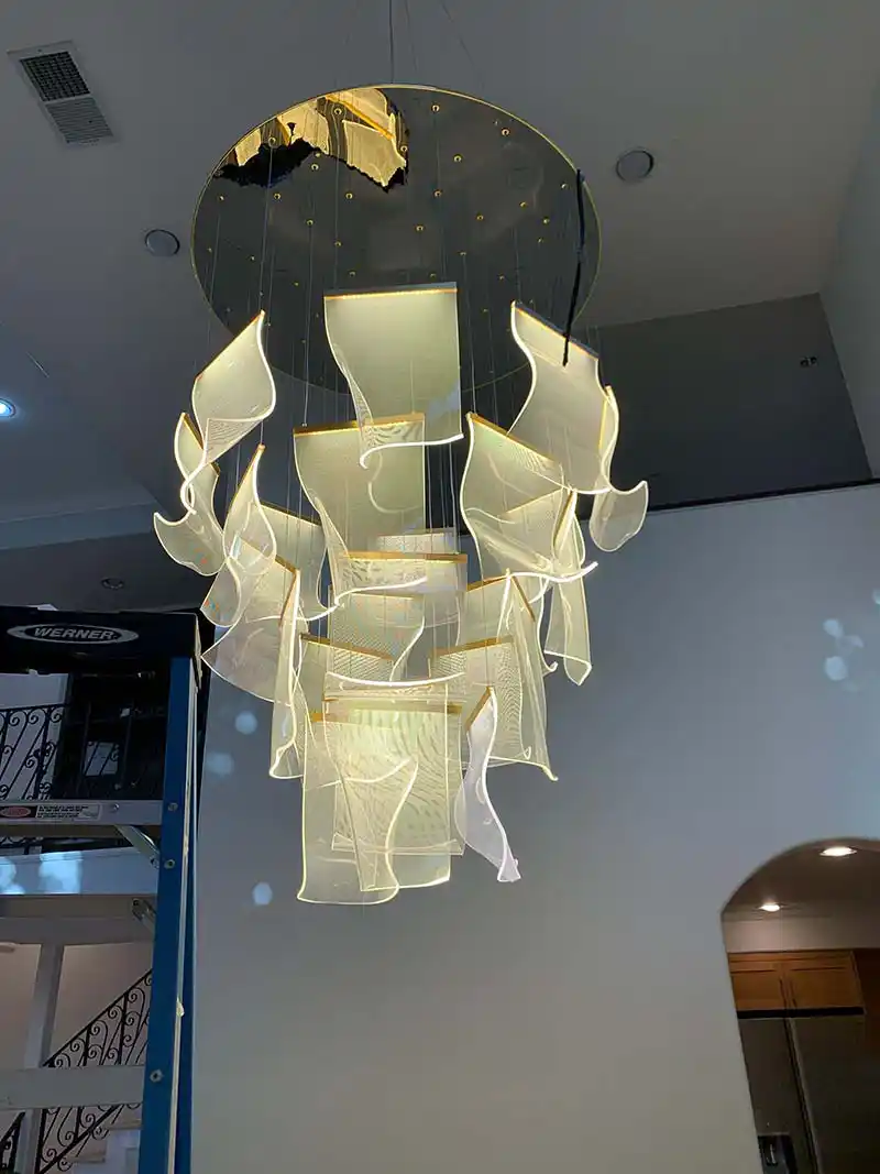 Grand foyer chandelier installation with scaffolding by licensed electrician in Southern California