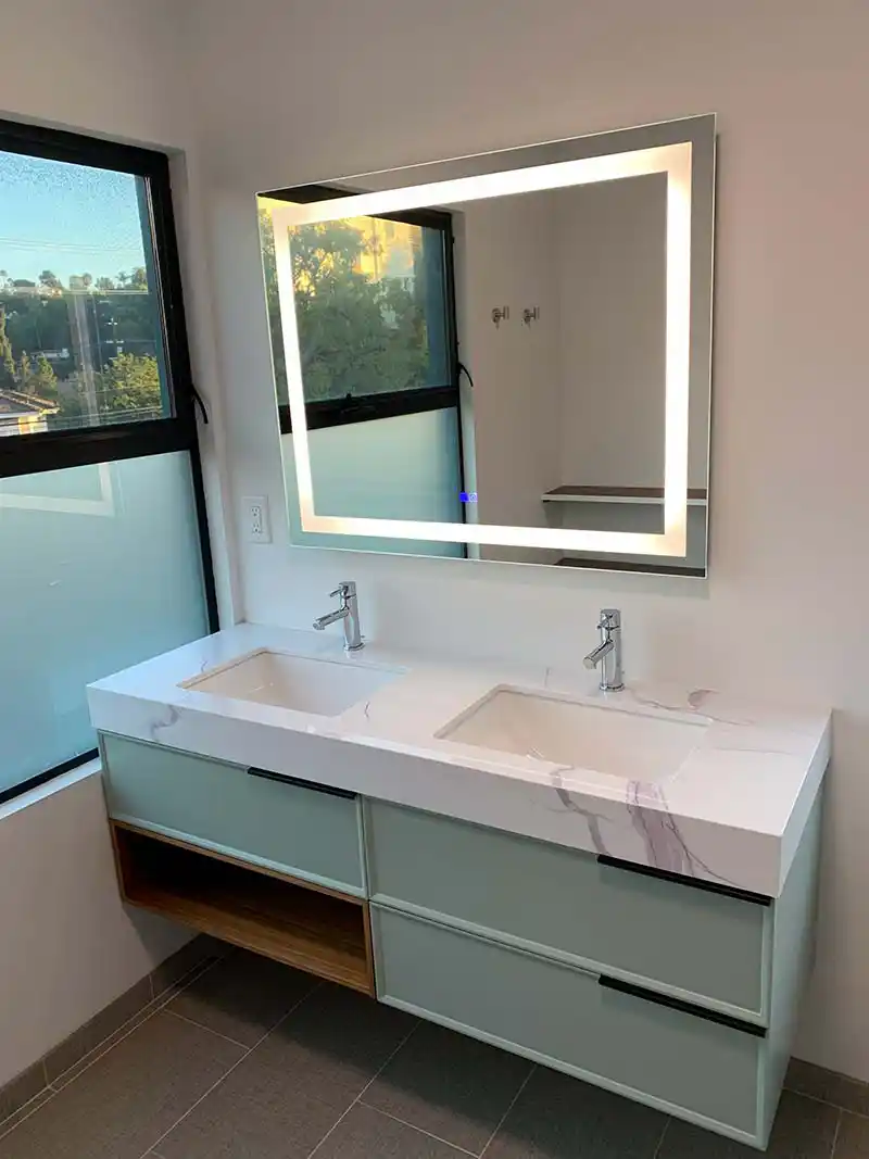 Modern bathroom vanity with integrated LED mirror lighting installation in SoCal